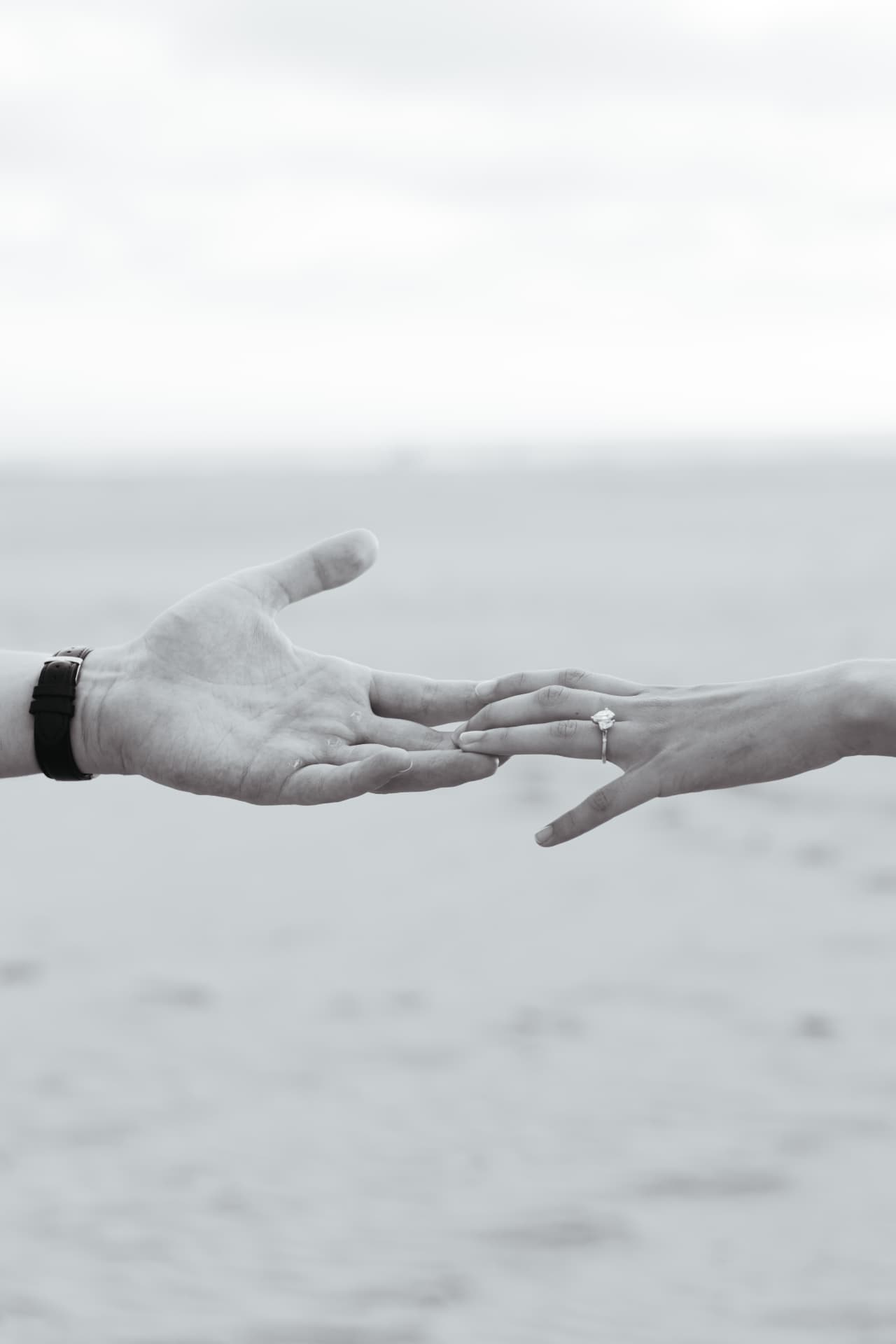 Lars and Ine-Mari reaching for each other, engagement ring